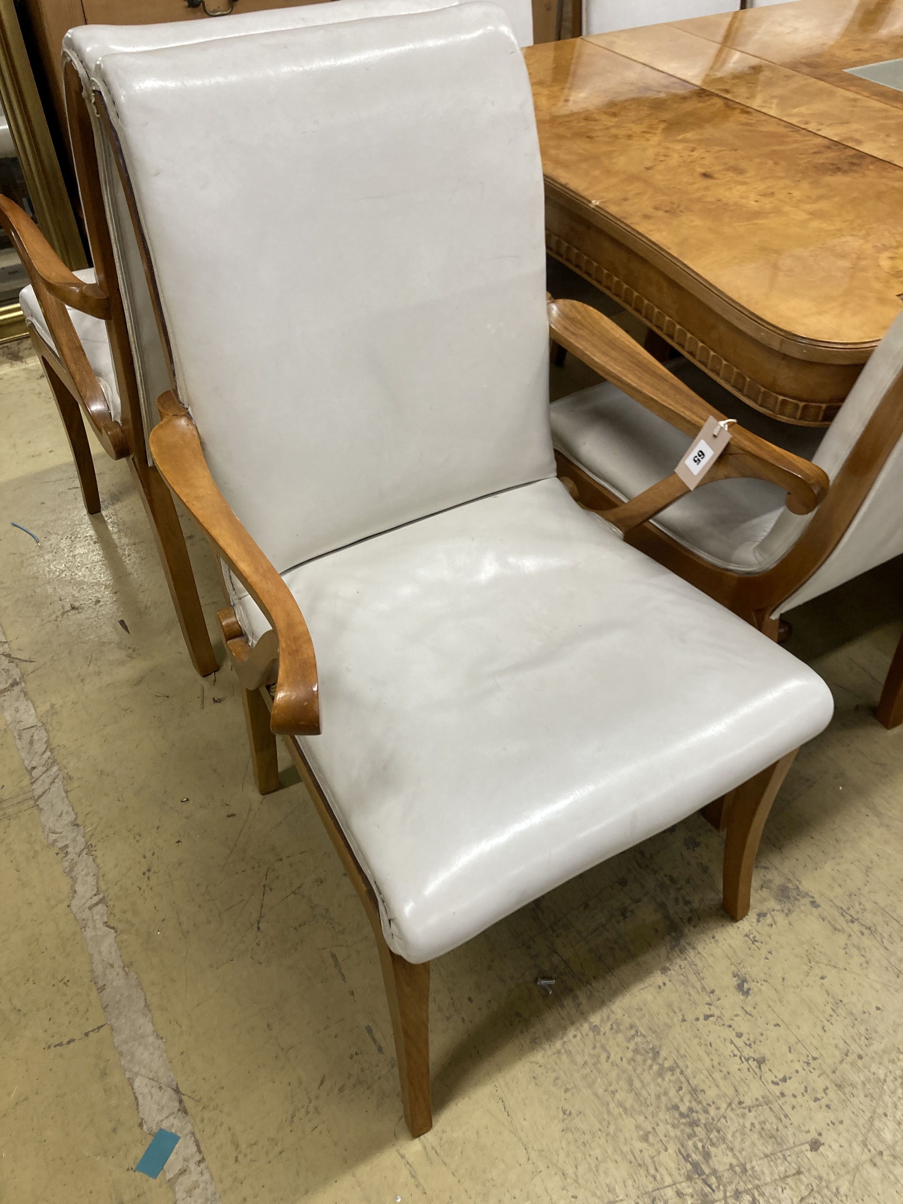 A mid century birds eye maple and walnut dining suite, comprising extending table, 205cm, depth 106cm, height 76cm, a set of ten dining